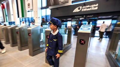 A young passenger is dressed for the occasion as he heads to the Etihad Rail passenger train