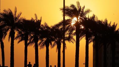 Spectators watch from a terrace of a hotel during sunset qualifying at Yas Marina. Luca Bruno/AP