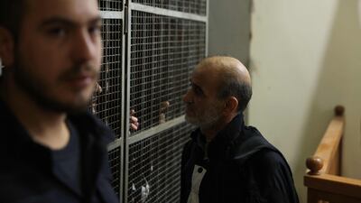 A man speaks with the accused. AFP
