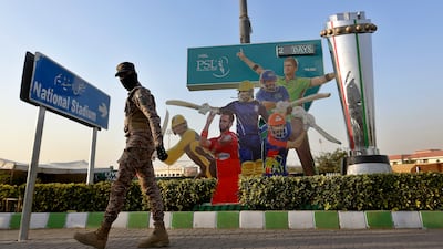 A paramilitary soldier patrols next to cutouts of cricket players displaying outside the National Stadium for the upcoming country's premier domestic Twenty20 tournament 'Pakistan Super League' in Karachi, Pakistan, Tuesday, Jan. 25, 2022. The Pakistan Cricket Board says "robust" COVID-19 health and safety protocols are in place ahead of its month-long domestic Twenty20 competition in Karachi and Lahore, with several foreign cricketers participating in a six-team event. (AP Photo / Fareed Khan)