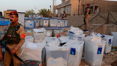 Iraqi security forces guard ballot boxes after a fire that broke out at Baghdad's largest ballot box storage site, where ballots from May's parliamentary elections are stored, on June 10. AP