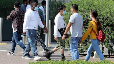 People wearing a protective face mask as a preventive measure against the spread of coronavirus in the Bur Dubai area in Dubai.