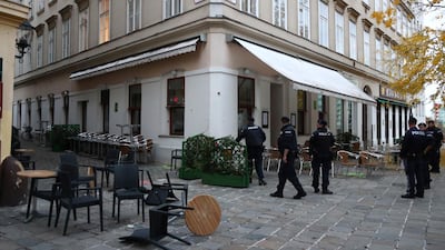 Police officers guard the crime scene at a bar in Vienna, Austria, Tuesday, Nov. 3, 2020. Several shots were fired shortly after 8 p.m. local time on Monday, Nov. 2, in a lively street in the city center of Vienna. (AP Photo/Matthias Schrader)