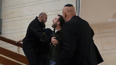Security guards prevent a protester from entering the parliament building. AP