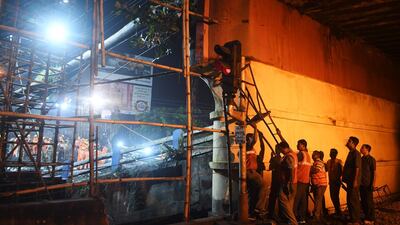 Workers repair a damaged signal system. AFP