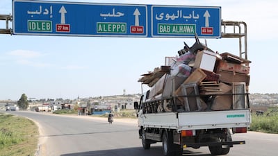 Residents flee Idlib with their belongings during shelling by government and allied forces. AFP