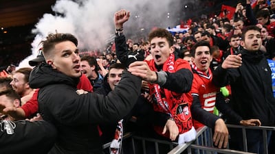 Rennes midfielder Adrien Hunou celebrates with supporters after winning the French Cup on Saturday night. Anne-Christine Poujoulat / AFP