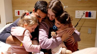 Two-year-old Aviv Asher and her four-year-old sister Raz are embraced by their mother Doron and father Yoni at the Schneider Children's Medical Centre in Israel. Reuters