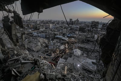 Palestinians gather between destroyed houses to break their fast together during Ramadan in the northern Gaza Strip. Muslims around the world observe the holy month by praying at night and abstaining from eating and drinking between sunrise and sunset. EPA
