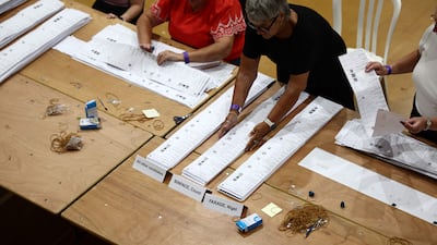 Counters sort the ballot papers, which were the longest in UK electoral history, with a record 34 candidates standing. AFP