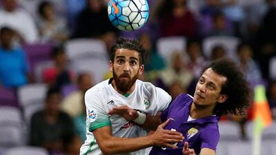 Zobahan's Ali Hamam, left, fights for the ball with Al Ain's Mohammed Abdulrahman. Marwan Naamani / AFP