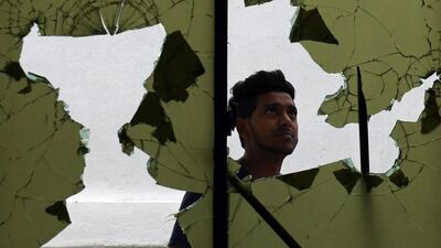 A man stands in front of the Jumha mosque after a mob attack. AFP