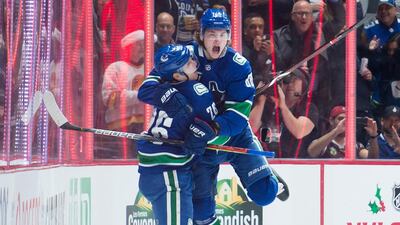 Vancouver Canucks left wing Antoine Roussel celebrates his goal with Adam Gaudette during the first period of an NHL hockey game against the Vegas Golden Knights, in Vancouver, British Columbia. AP Photo