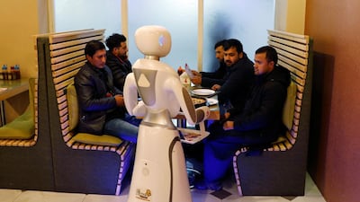 Timea brings food to a table at the Times Fast Food restaurant in Kabul, Afghanistan. Reuters