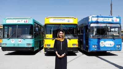 Karim poses for photos in front of the mobile library buses.