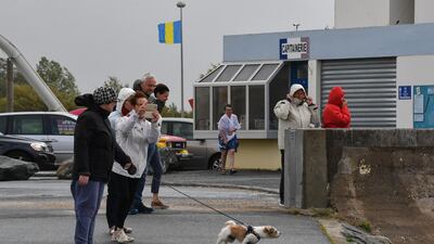 People look at rough sea in Angoulins's harbour, southwestern France during Miguel storm. AFP