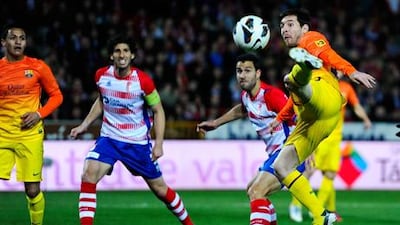 Lionel Messi scissor kicks the ball during Barcelona's win at Granada.