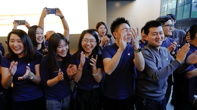 Apple staff cheer as the first customer for iPhone X enters an Apple Store in Beijing, China. Damir Sagolj / Reuters