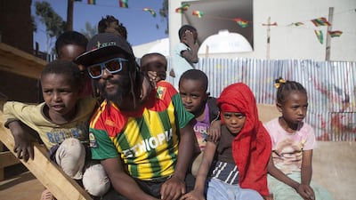 Ethiopian musician Israel Dejene Male, owner of Megabiskate, poses with local children from the Shiro Meda neighbourhood of Addis Ababa on March 3, 2015. 'There’s nothing for the kids in the neighbourhood, nothing to inspire them,' said Israel Dejene, who teaches local children how to skateboard. Zacharias Abubeker/AFP Photo
