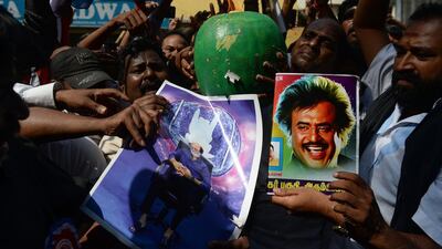 Indian fans of Rajinikanth celebrate after his announcement that he will enter into politics. Arun Sankar / AFP