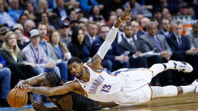 Oklahoma City Thunder forward Paul George dives for the ball during an NBA basketball game in Oklahoma City. AP Photo