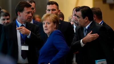 Germany's Chancellor Angela Merkel (C) gestures as she arrives ahead of a summit at EU headquarters in Brussels on June 24, 2018. EU leaders headed to Brussels for emergency talks over migration as Italy's new populist cabinet turned away another rescue ship, vowing no longer to shoulder Europe's migrant burden. / AFP / JOHN THYS