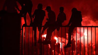 Fans celebrate Liverpool winning the Premier League title outside Anfield stadium. AFP