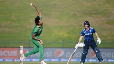 Pakistan’s Mohammad Irfan, left, bowls under the watchful eye of England’s Eoin Morgan in Abu Dhabi on Wednesday. Gareth Copley / Getty Images