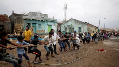 People attempt to salvage a boat damaged when Cyclone Tauktae hit Navabandar village, in the western state of Gujarat, India. Reuters