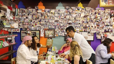 Majeed Al Ustad serves tea to his customers.