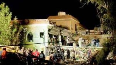 Kuwaiti authorities search a damaged Islamic prayer hall after an explosion on Sunday.