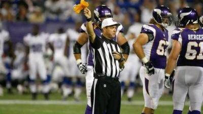 Referee Robert Frazer signals a penalty during a preseason game between the Minnesota Vikings and the Buffalo Bills.
