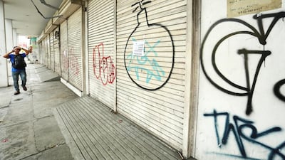 The building where Aiza Tonida used to work in Tacloban City is now shuttered down and covered with graffiti. (Joey Reyna for The National / April 10, 2014)