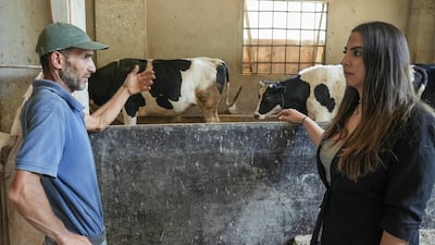 Cheese maker Marie Georges Hatem talks to a dairy farmer.