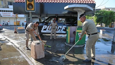 Iraqi security forces clean a street in the capital's Karrada district after a curfew was lifted following a day of violent protests. AFP