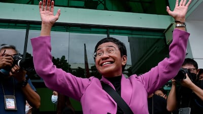 Maria Ressa, chief executive of online news site Rappler, waves outside a court in Quezon City, in the Philippines, after she was acquitted of tax evasion on Wednesday. AFP