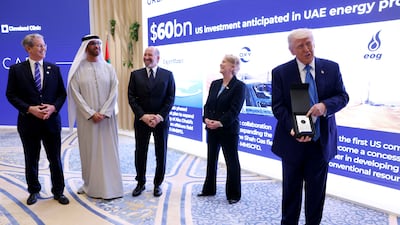 US President Donald Trump and Dr Sultan Al Jaber, managing director and group chief executive of Adnoc, at a meeting with UAE business leaders in Abu Dhabi on Friday. Chris Whiteoak / The National