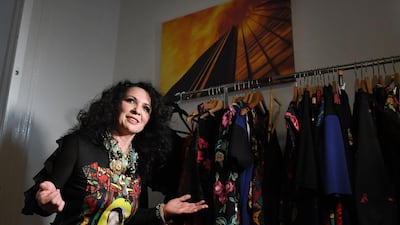 Hungarian Roma fashion designer Helen Varga stands in front of some designs. AFP