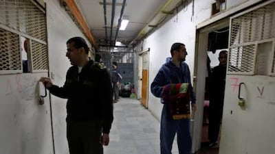 A Palestinian prison guard, left, and Palestinian Hamas prisoners are seen at Jneid Prison in the West Bank city of Nablus.