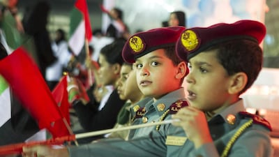 Children wave flags and sing at the Abu Dhabi Youth Festival in celebration of National Day at the weekend. The festivities featured camel and horse rides, musical bands, singers, poets and Emirati food. Mona Al Marzooqi / The National