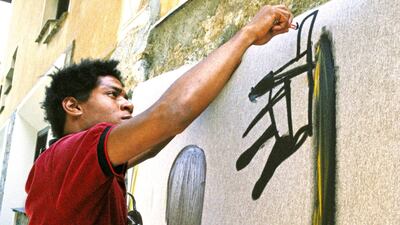Artist Jean-Michel painting in 1983 in St. Moritz, Switzerland. Photo: Getty Images