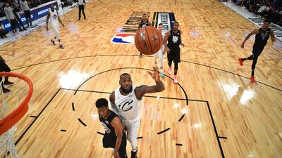 Lebron James, centre right, of Team Lebron goes to the basket over Kyle Lowry of Team Stephen. Bob Donnan / EPA