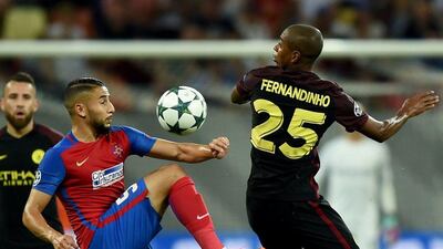 Manchester City's Fernandinho vies for the ball with Steaua Bucharest's Jugurtha Hamroun. (AFP)