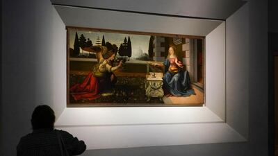 A journalist admires the 15th-century painting 'Annunciation' by Leonardo Da Vinci. AP Photo/Andrew Medichini