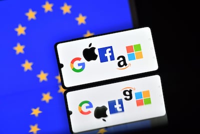The logos of Google, Apple, Facebook, Amazon and Microsoft displayed on a mobile phone with an EU flag in the background. AFP