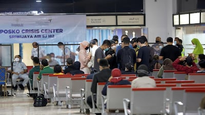 People are seen at a temporary crisis centre organised in the domestic terminal of Soekarno-Hatta International Airport, after Sriwijaya Air plane flight SJ182 lost contact after taking off, in Tangerang, near Jakarta, Indonesia. REUTERS