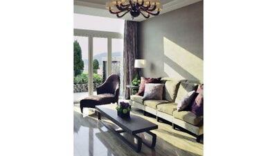 The Donghia armchair and sofa were the starting points for the living and dining area's colour palette. The chandelier is from Barovier & Toso, while the coffee table is from Promemoria.