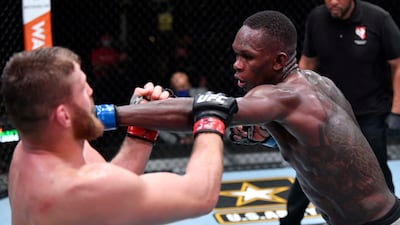 Israel Adesanya of Nigeria punches Jan Blachowicz of Poland in their light heavyweight championship fight at UFC 259 in Las Vegas, Nevada. Zuffa LLC / Getty Images