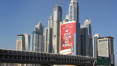 Prices in Dubai’s property market grew by as much as 40 per cent last year. Above, a tower with a sign that reads Keep Calm, No Bubble at the Marina district. Kamran Jebreili / AP Photo
