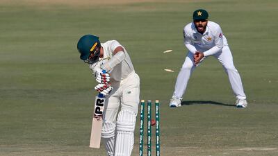 South Africa's Keshav Maharaj, front, is bowled by Pakistan's pacer Hasan Ali . AP